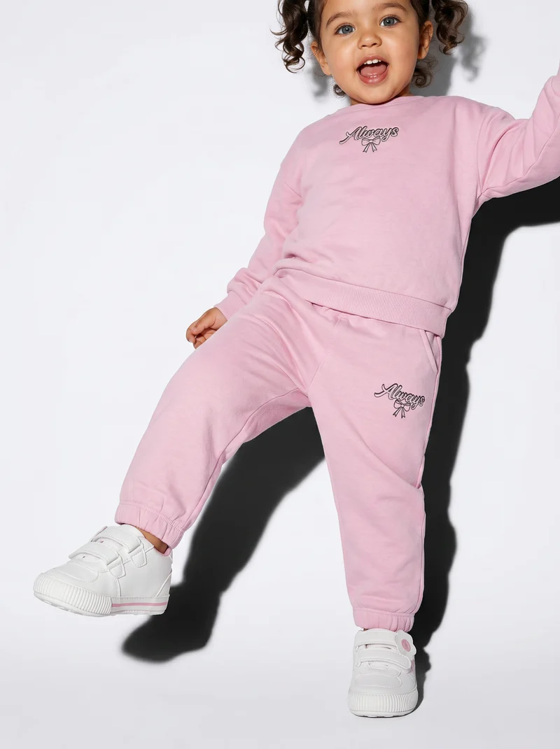 Jogger in cotone con fiocco e patch - Rosa polvere